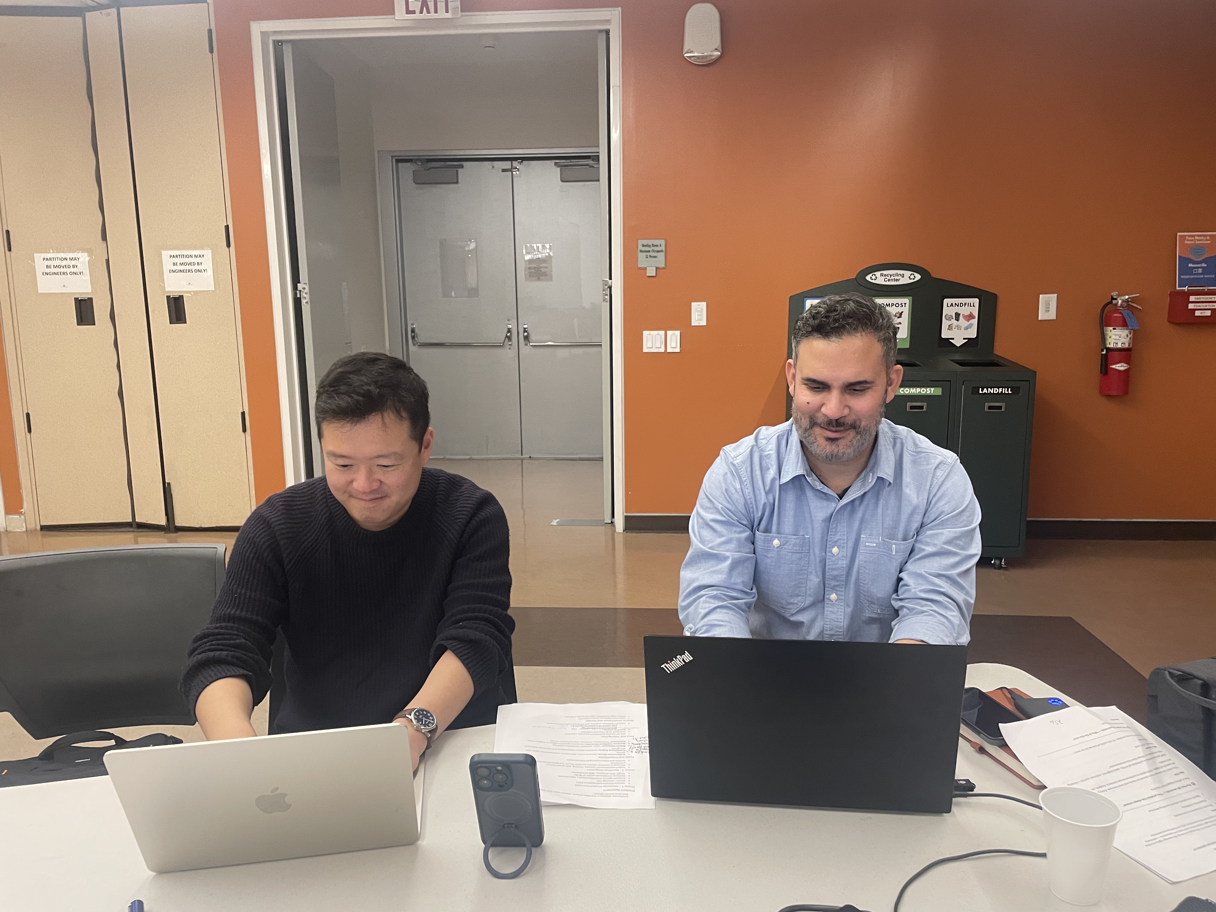 Two mentors working through a pilot together on their laptops